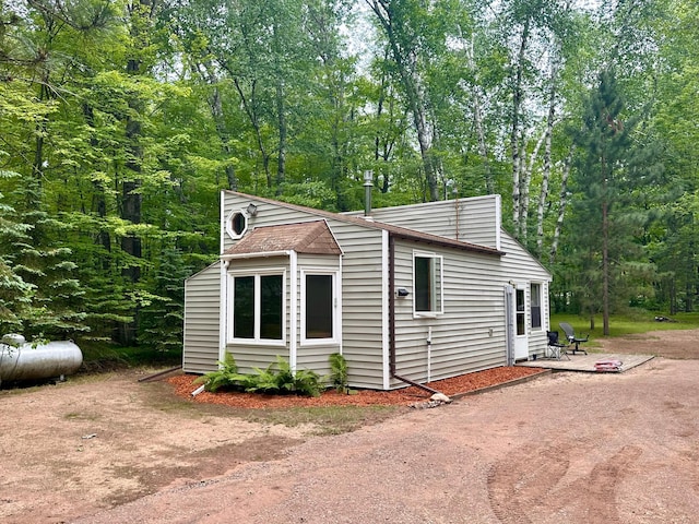 87102 Alder Loop, Sturgeon Lake, MN 55783 - view of property exterior featuring a patio area and a wooded view