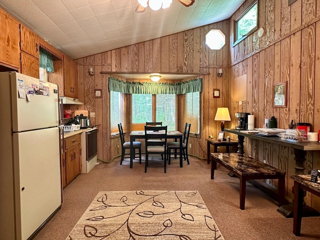 87102 Alder Loop, Sturgeon Lake, MN 55783 - dining room with wooden walls, light carpet, ceiling fan, and high vaulted ceiling