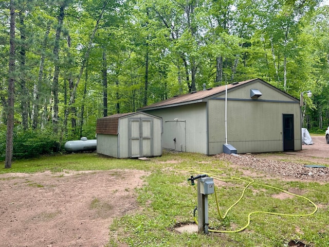 87102 Alder Loop, Sturgeon Lake, MN 55783 - view of shed with a view of trees