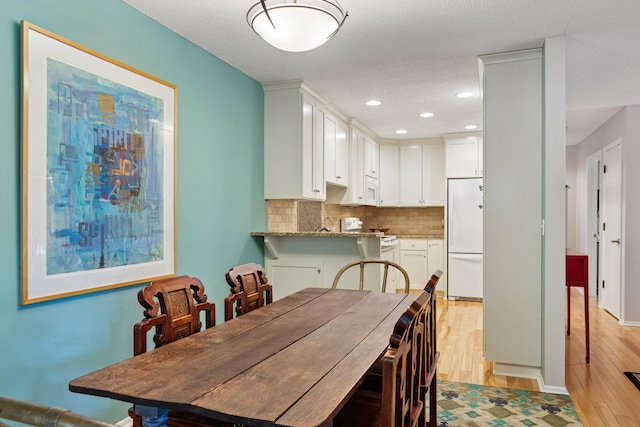 8447 Morgan Ln, Eden Prairie, MN 55347 - dining space with light wood-type flooring, recessed lighting, and a textured ceiling