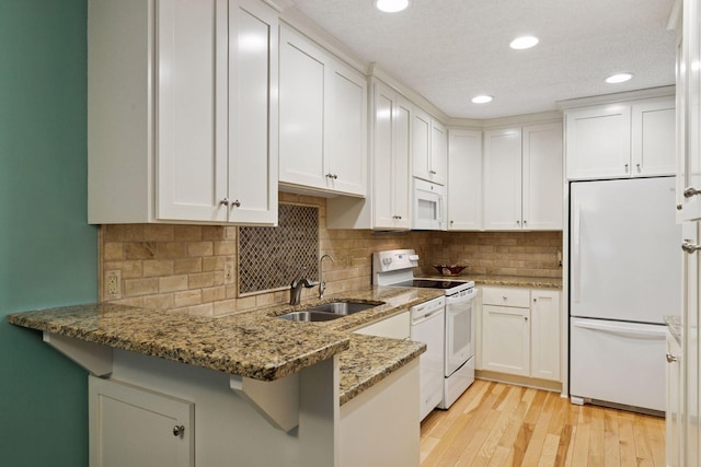 8447 Morgan Ln, Eden Prairie, MN 55347 - kitchen featuring white appliances, a peninsula, white cabinetry, light stone countertops, and recessed lighting