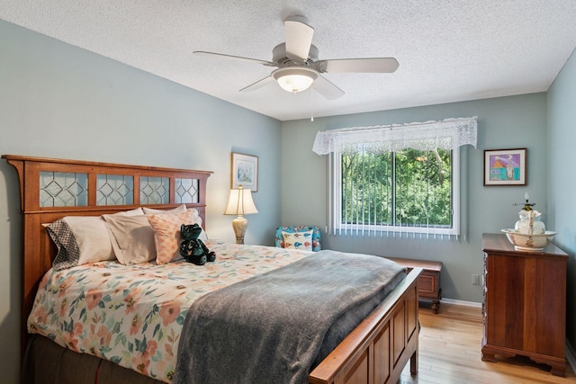 8447 Morgan Ln, Eden Prairie, MN 55347 - bedroom with light wood-type flooring, a textured ceiling, and ceiling fan
