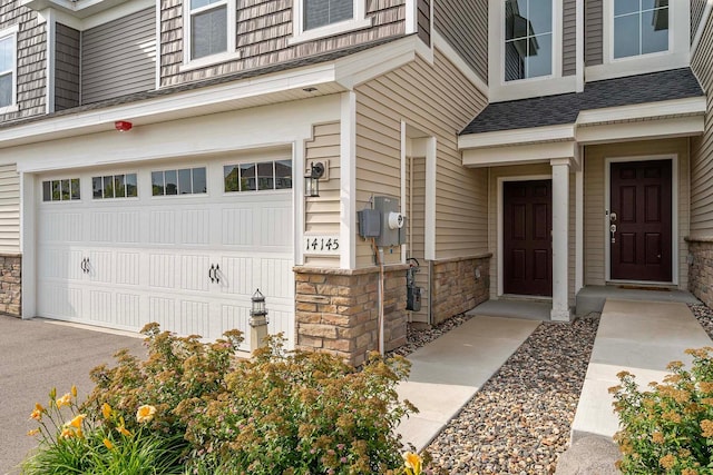 14145 Aberdeen Way, Rosemount, MN 55068 - property entrance featuring a garage and stone siding