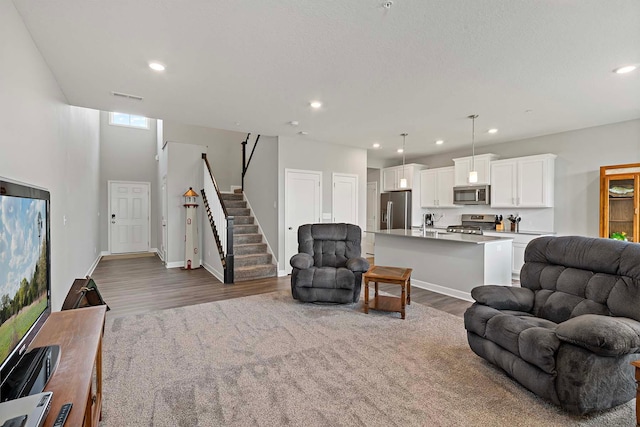 14145 Aberdeen Way, Rosemount, MN 55068 - living area featuring dark wood finished floors, stairway, and recessed lighting