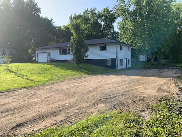 511 2nd St S, Watkins, MN 55389 - ranch-style home with dirt driveway, a garage, and a front lawn