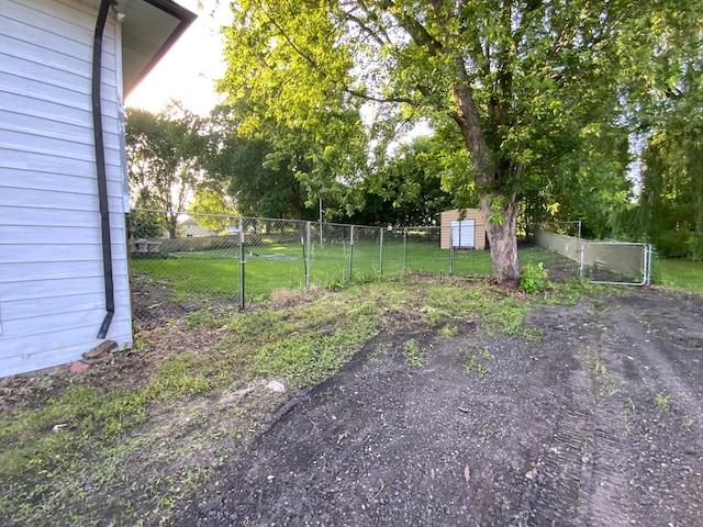 511 2nd St S, Watkins, MN 55389 - view of yard featuring a shed and view of wooded area