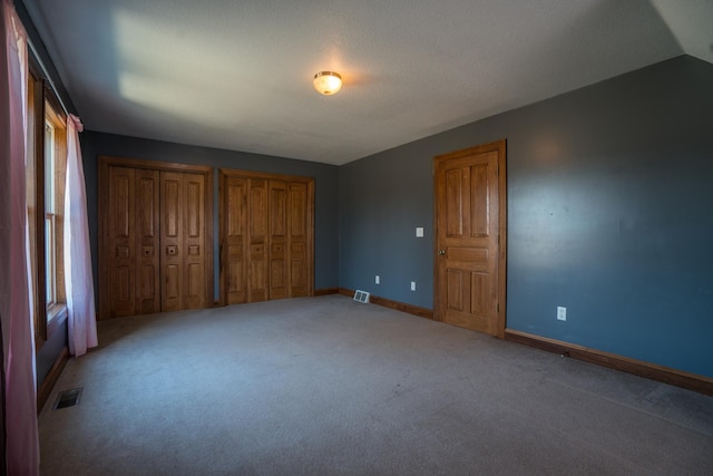 1757 325th Ave, West Sweden Twp, WI 54837 - unfurnished bedroom featuring two closets and light carpet