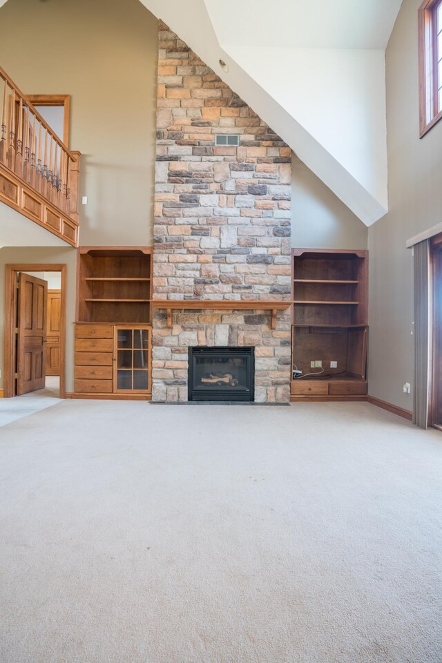 1757 325th Ave, West Sweden Twp, WI 54837 - unfurnished living room featuring a high ceiling, carpet flooring, and a fireplace