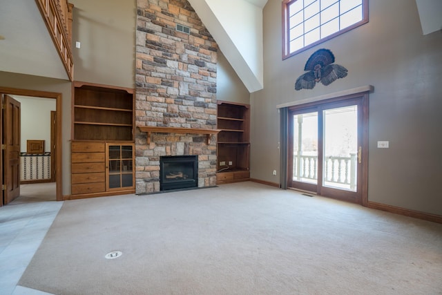 1757 325th Ave, West Sweden Twp, WI 54837 - unfurnished living room with a high ceiling, plenty of natural light, a stone fireplace, and carpet