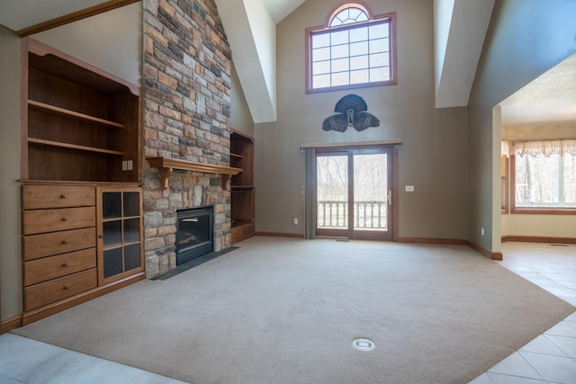 1757 325th Ave, West Sweden Twp, WI 54837 - unfurnished living room with high vaulted ceiling, tile patterned floors, a fireplace, built in features, and carpet floors