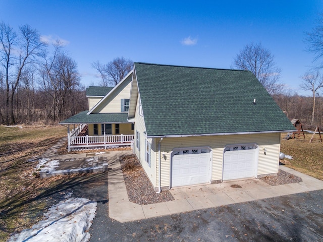 1757 325th Ave, West Sweden Twp, WI 54837 - view of side of home with covered porch, roof with shingles, and a detached garage