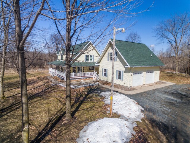 1757 325th Ave, West Sweden Twp, WI 54837 - view of front of property with a porch, a shingled roof, and a garage