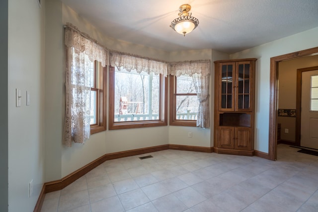 1757 325th Ave, West Sweden Twp, WI 54837 - unfurnished dining area with baseboards and light tile patterned flooring