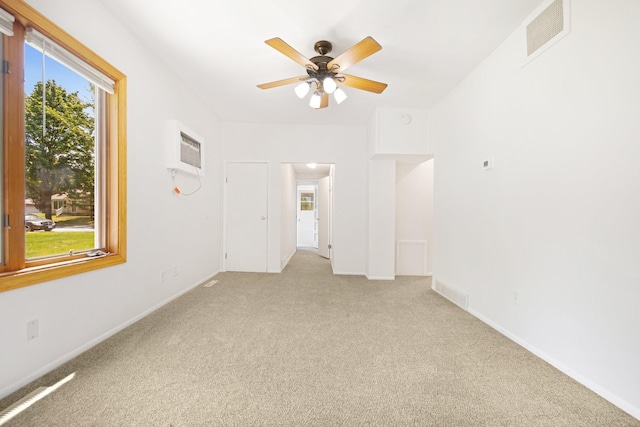 619 4th Ave E, Shakopee, MN 55379 - unfurnished room featuring light colored carpet, a wall mounted AC, and a ceiling fan