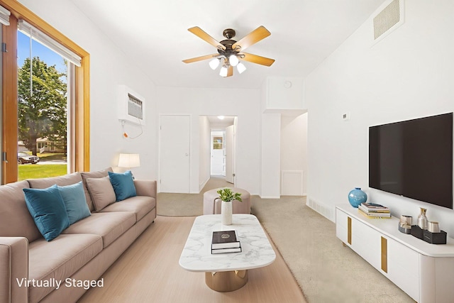 619 4th Ave E, Shakopee, MN 55379 - living area with light colored carpet, a ceiling fan, and a wall mounted air conditioner