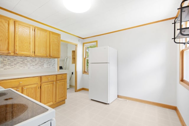 619 4th Ave E, Shakopee, MN 55379 - kitchen with white appliances, washer / dryer, light floors, decorative backsplash, and light countertops