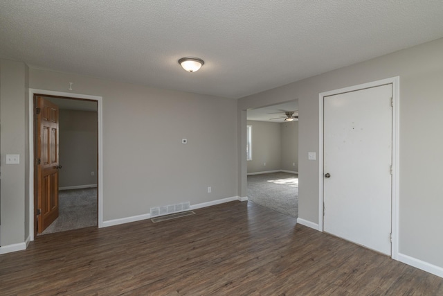 269 Chestnut St, Ellsworth, WI 54011 - spare room featuring dark wood-style floors, ceiling fan, and a textured ceiling