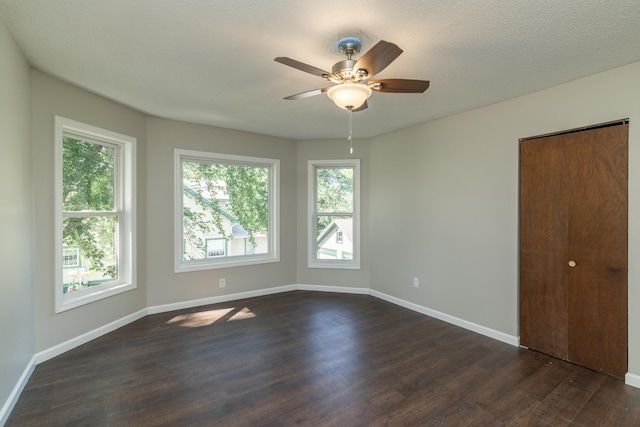 269 Chestnut St, Ellsworth, WI 54011 - empty room featuring dark wood-style flooring and ceiling fan