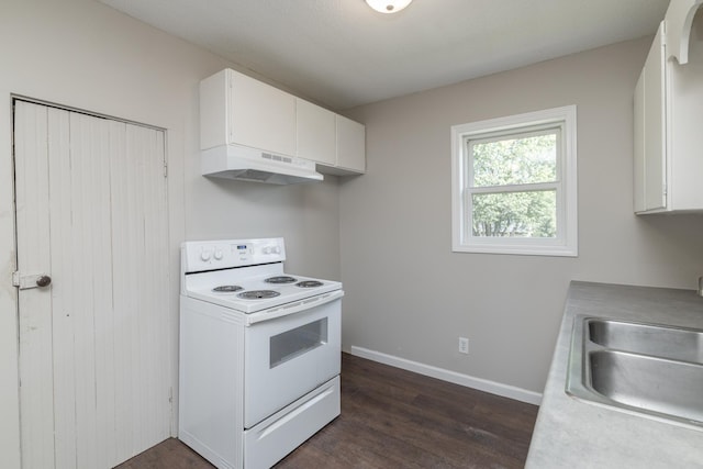 269 Chestnut St, Ellsworth, WI 54011 - kitchen with electric stove, under cabinet range hood, dark wood-style floors, light countertops, and white cabinets