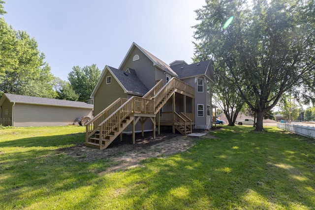 269 Chestnut St, Ellsworth, WI 54011 - rear view of property featuring stairs, a lawn, roof with shingles, and a deck