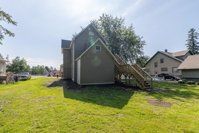 269 Chestnut St, Ellsworth, WI 54011 - back of house featuring stairway and a yard