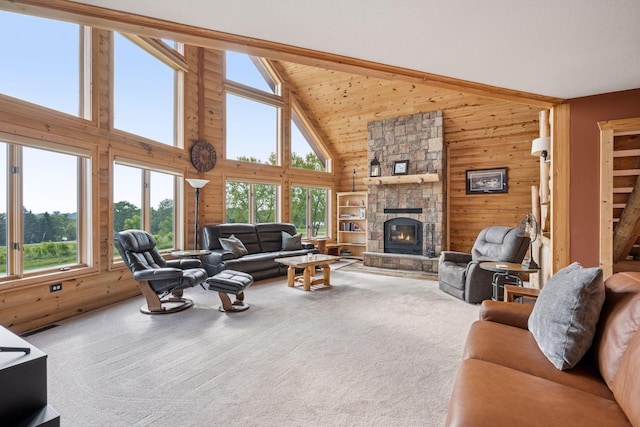 70824 227th St, Dassel Twp, MN 55325 - living area with wood walls, high vaulted ceiling, a stone fireplace, and carpet flooring