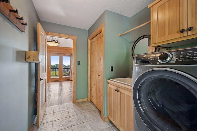 70824 227th St, Dassel Twp, MN 55325 - washroom featuring washer / dryer, cabinet space, a textured ceiling, and french doors