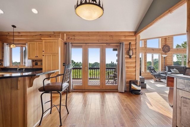 70824 227th St, Dassel Twp, MN 55325 - kitchen featuring a kitchen bar, light wood-style floors, recessed lighting, dark countertops, and french doors