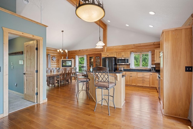 70824 227th St, Dassel Twp, MN 55325 - kitchen with appliances with stainless steel finishes, light brown cabinets, a kitchen breakfast bar, dark countertops, and light wood-style flooring
