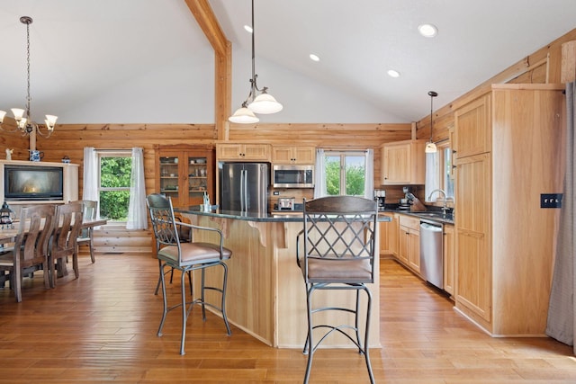 70824 227th St, Dassel Twp, MN 55325 - kitchen with stainless steel appliances, light brown cabinets, dark countertops, a center island, and a breakfast bar area