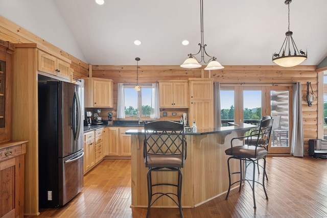 70824 227th St, Dassel Twp, MN 55325 - kitchen featuring freestanding refrigerator, light brown cabinetry, vaulted ceiling, dark countertops, and light wood finished floors