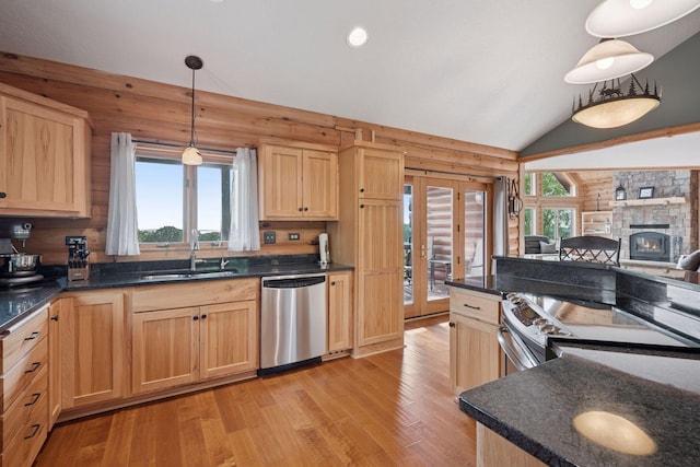 70824 227th St, Dassel Twp, MN 55325 - kitchen with stainless steel appliances, light brown cabinets, light wood-type flooring, log walls, and vaulted ceiling