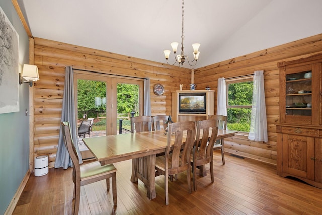 70824 227th St, Dassel Twp, MN 55325 - dining room with a chandelier, lofted ceiling, hardwood / wood-style flooring, and rustic walls