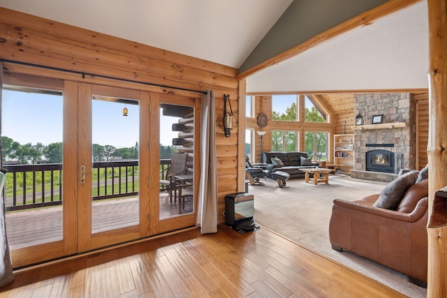 70824 227th St, Dassel Twp, MN 55325 - living room featuring high vaulted ceiling, a fireplace, hardwood / wood-style floors, and wooden walls