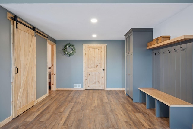 70824 227th St, Dassel Twp, MN 55325 - mudroom featuring a barn door, wood finished floors, and recessed lighting