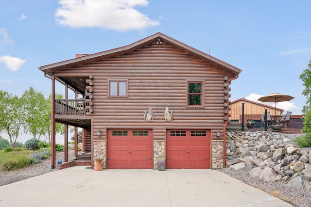 70824 227th St, Dassel Twp, MN 55325 - view of side of property with log exterior, driveway, a garage, and stone siding
