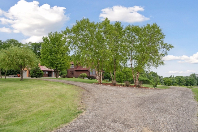 70824 227th St, Dassel Twp, MN 55325 - obstructed view of property featuring a front lawn and curved driveway