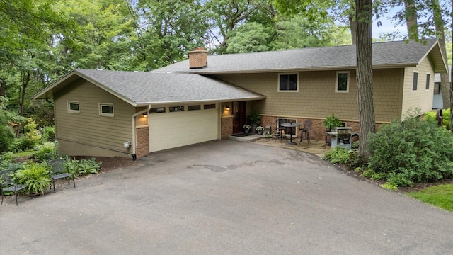 520 Wedgewood Ln N, Plymouth, MN 55441 - view of front of home featuring a chimney, driveway, brick siding, an attached garage, and roof with shingles