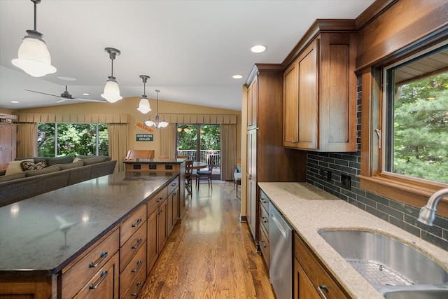 520 Wedgewood Ln N, Plymouth, MN 55441 - kitchen featuring dishwasher, wood finished floors, tasteful backsplash, brown cabinetry, and vaulted ceiling