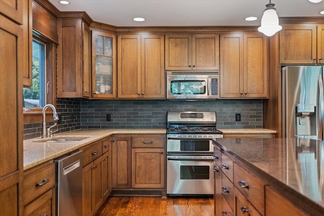 520 Wedgewood Ln N, Plymouth, MN 55441 - kitchen with stainless steel appliances, brown cabinetry, light stone countertops, and recessed lighting
