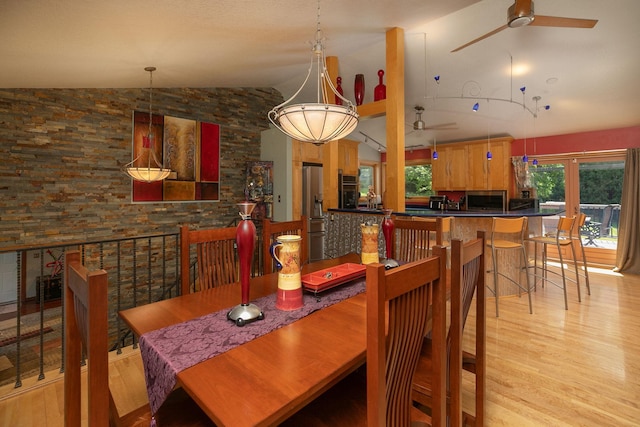 175 6th Ln NE, Oronoco, MN 55960 - dining room featuring a ceiling fan, vaulted ceiling, and light wood-type flooring