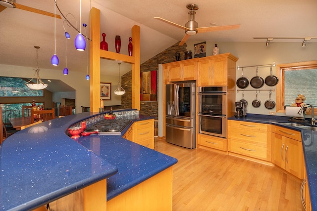 175 6th Ln NE, Oronoco, MN 55960 - kitchen featuring stainless steel appliances, a ceiling fan, light wood-style floors, vaulted ceiling, and dark countertops
