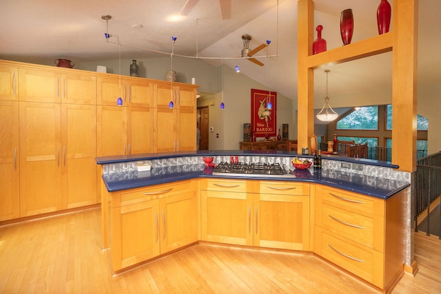 175 6th Ln NE, Oronoco, MN 55960 - kitchen featuring a ceiling fan, light wood-style flooring, dark countertops, stainless steel gas stovetop, and high vaulted ceiling