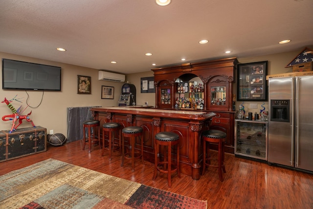 175 6th Ln NE, Oronoco, MN 55960 - indoor dry bar featuring high quality fridge, an AC wall unit, beverage cooler, dark wood-type flooring, and recessed lighting