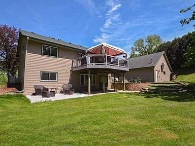 175 6th Ln NE, Oronoco, MN 55960 - rear view of house featuring a patio area, a lawn, a deck, and outdoor lounge area