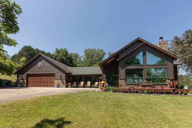 175 6th Ln NE, Oronoco, MN 55960 - view of front of home featuring driveway, a front yard, a chimney, and an attached garage