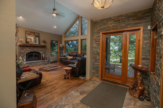 175 6th Ln NE, Oronoco, MN 55960 - living room with a glass covered fireplace, ceiling fan, and high vaulted ceiling