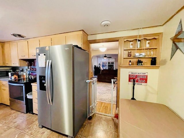 223 4th St, Virginia, MN 55792 - kitchen with stainless steel appliances, light tile patterned floors, ceiling fan, and light brown cabinets