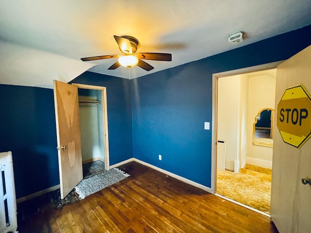 223 4th St, Virginia, MN 55792 - unfurnished bedroom featuring wood-type flooring, a closet, and ceiling fan
