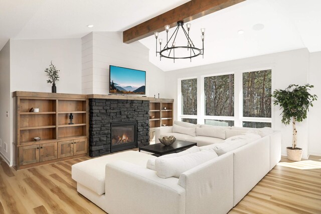 15359 Quamba St NE, Ham Lake, MN 55304 - living room with light wood finished floors, a chandelier, and a fireplace